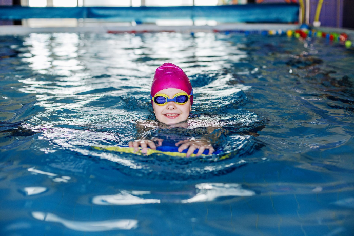 Enfant au cours de natation avec une planche chez Les bébés nageurs à Gerpinnes près de Charleroi
